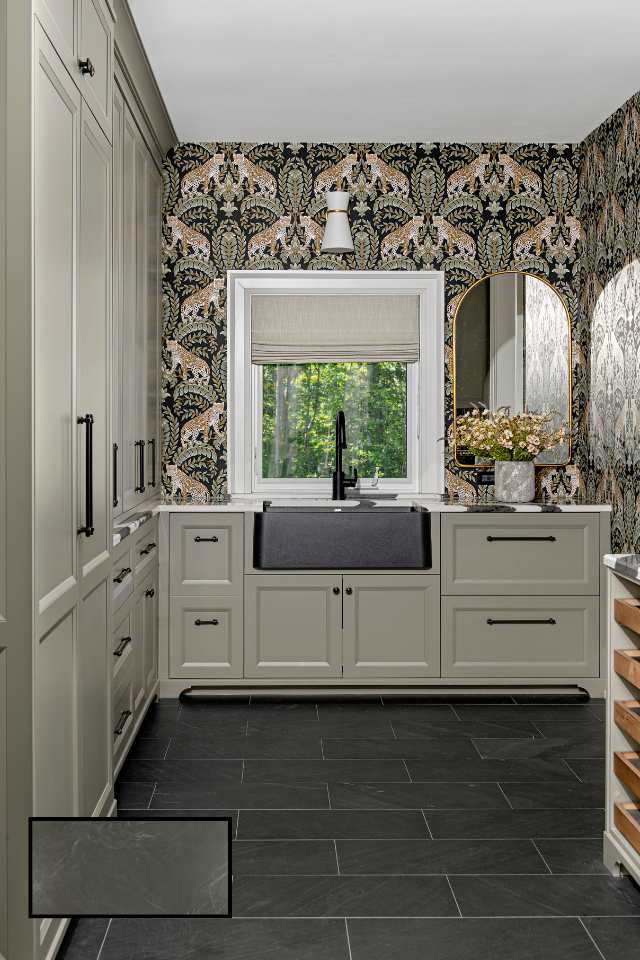eclectic wallpaper in mudroom with sage green cabinet storage and big farmhouse sink